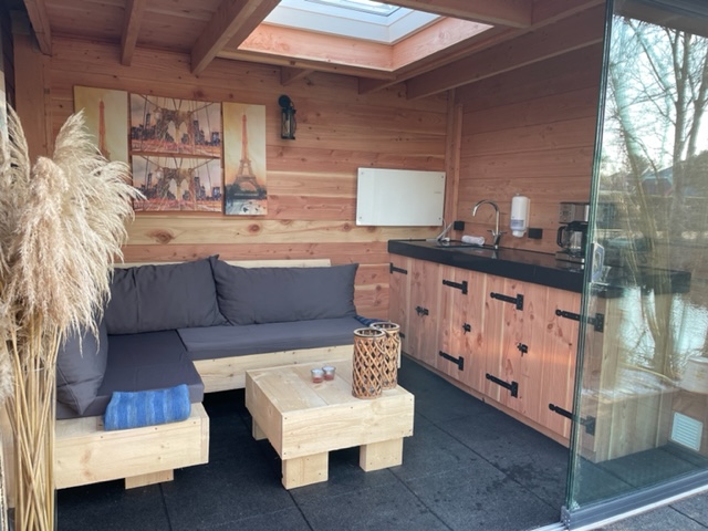 A peek into the lovely covered sitting area with outdoor kitchen!
