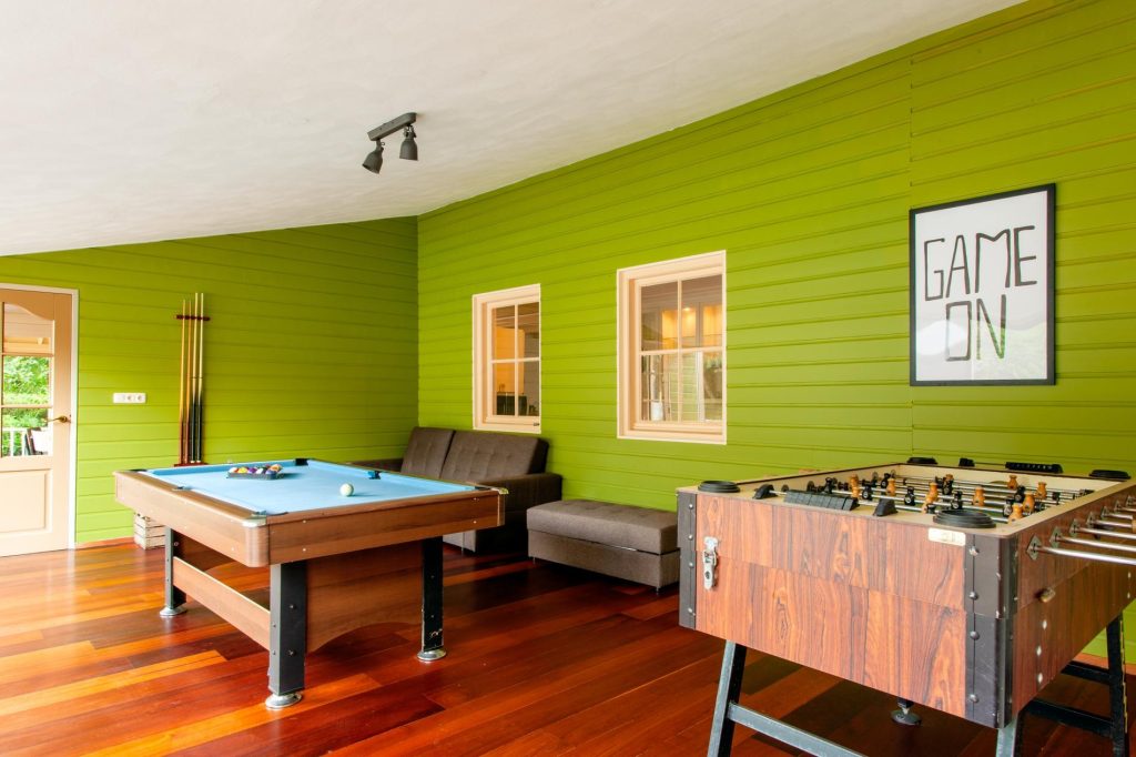 The game room of our luxury vacation home in Heerhugowaard, with a foosball table and a pool table! 