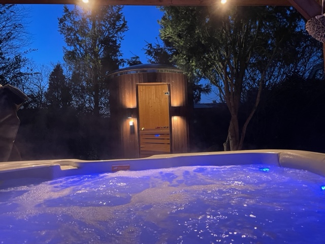 Het uitzicht vanuit de sfeervolle jacuzzi op de sauna! Dit huis is beschikbaar voor jou!